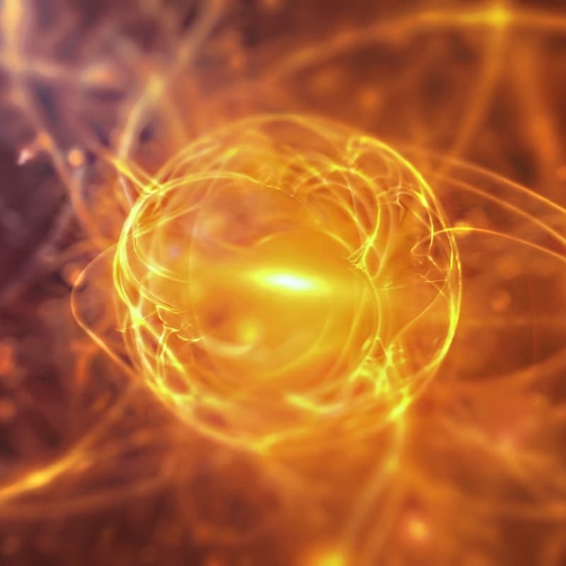 A glowing cell in a field of golden filaments