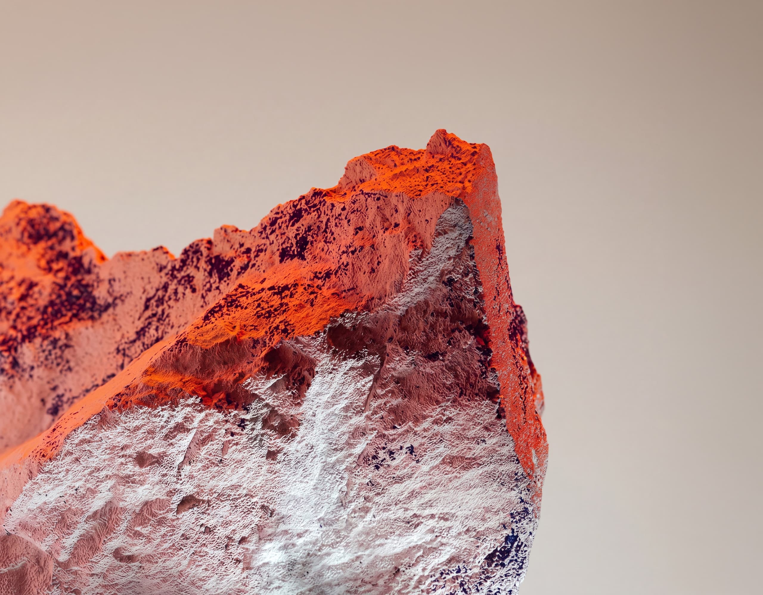 Red mineral ridge rising against a pale sky
